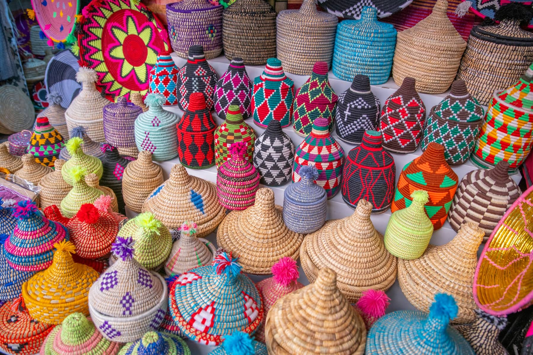 Colourful woven baskets stacked at a market