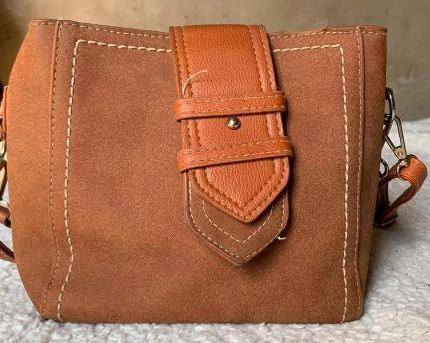 Tan suede bucket bag with buckle