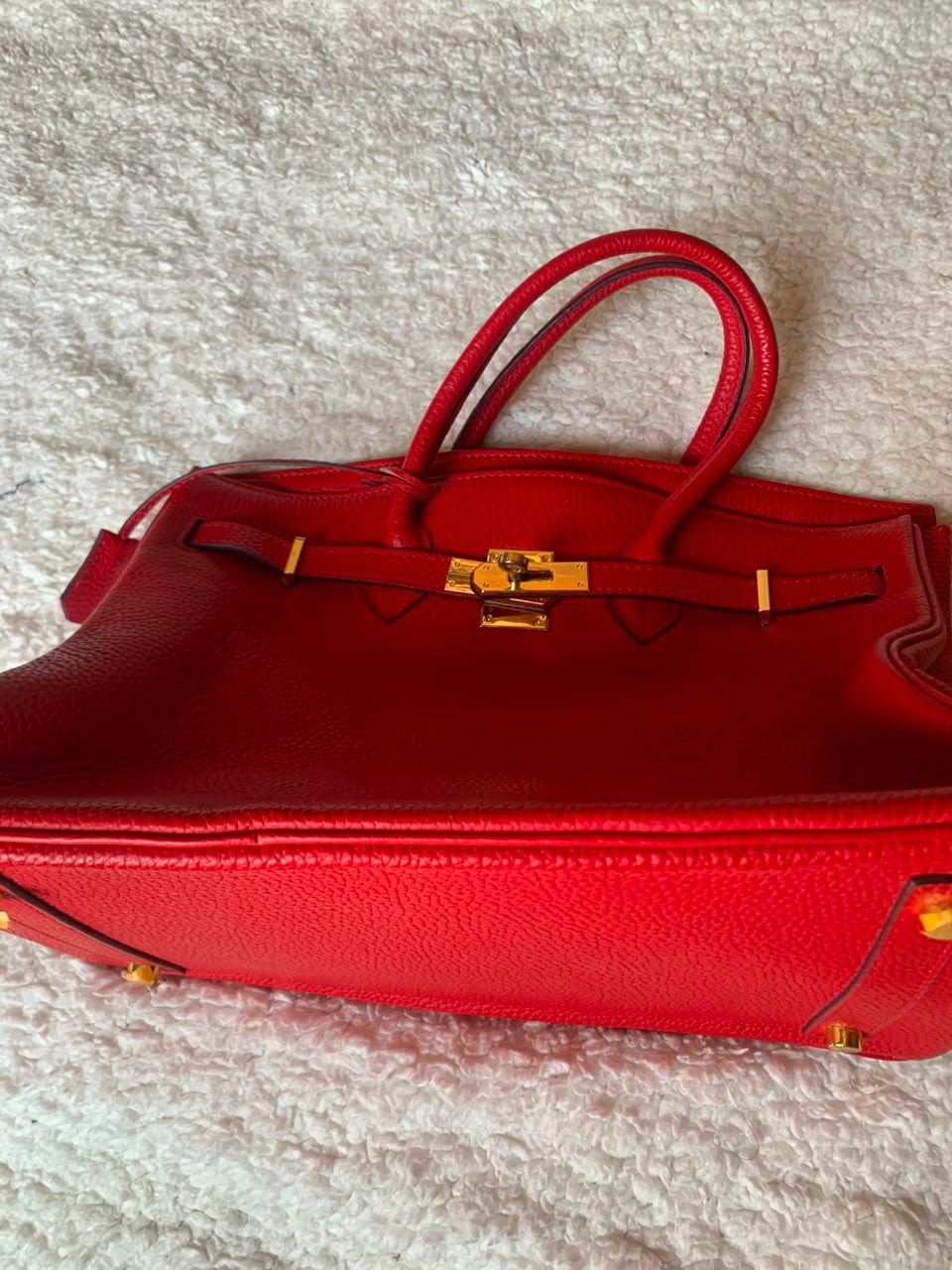 Red top-handle tote with gold lock
