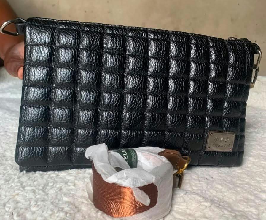 Black puffer-quilted clutch with strap