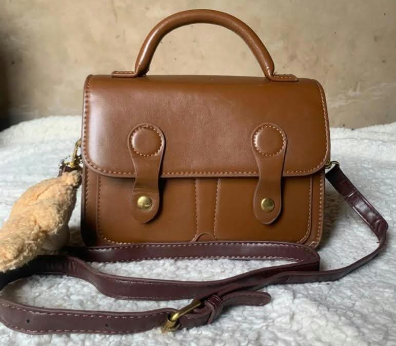 Tan satchel with crossbody strap